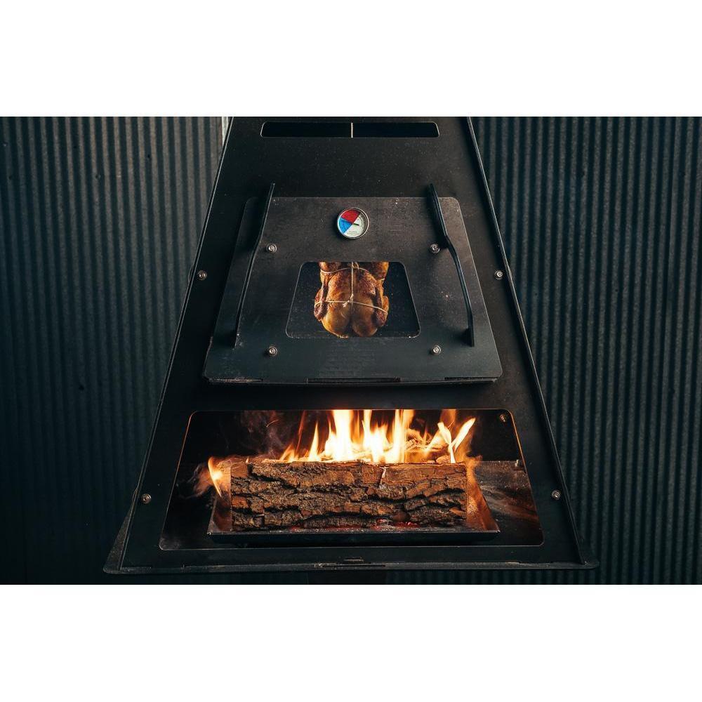 Hanging chicken to roast outside in a Pyro Tower wood fire oven