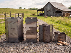 PYRO Burn Cage family size comparison — XXL hexagon, Large, Medium and Small on a farm drive