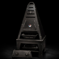Pyro Tower Complete Kit — thermometer top door, charcoal basket, grill grate and pedestal, studio view