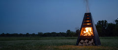 Pyro Tower burning at twilight on an open acreage