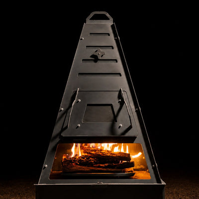 Pyro Tower Wood-Fired Oven Kit — oven door fitted, fire in the cooking chamber, studio view