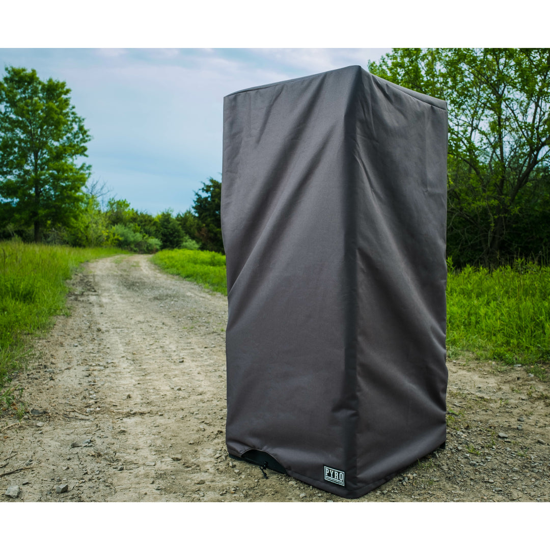 Charcoal custom-fit Pyro burn cage cover protecting a cage beside a gravel track