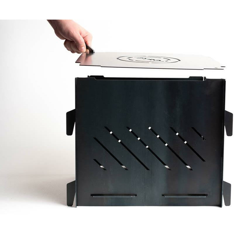 Lifting the lid off the Pyro Cage MINI portable fire pit by hand