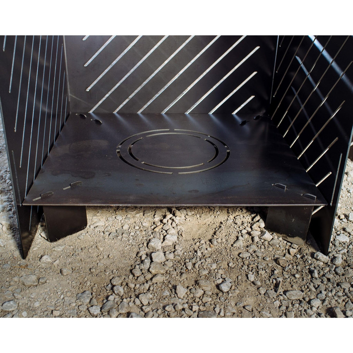 Riser base installed inside a Medium Pyro Cage, lifting the fire 4 inches off the ground