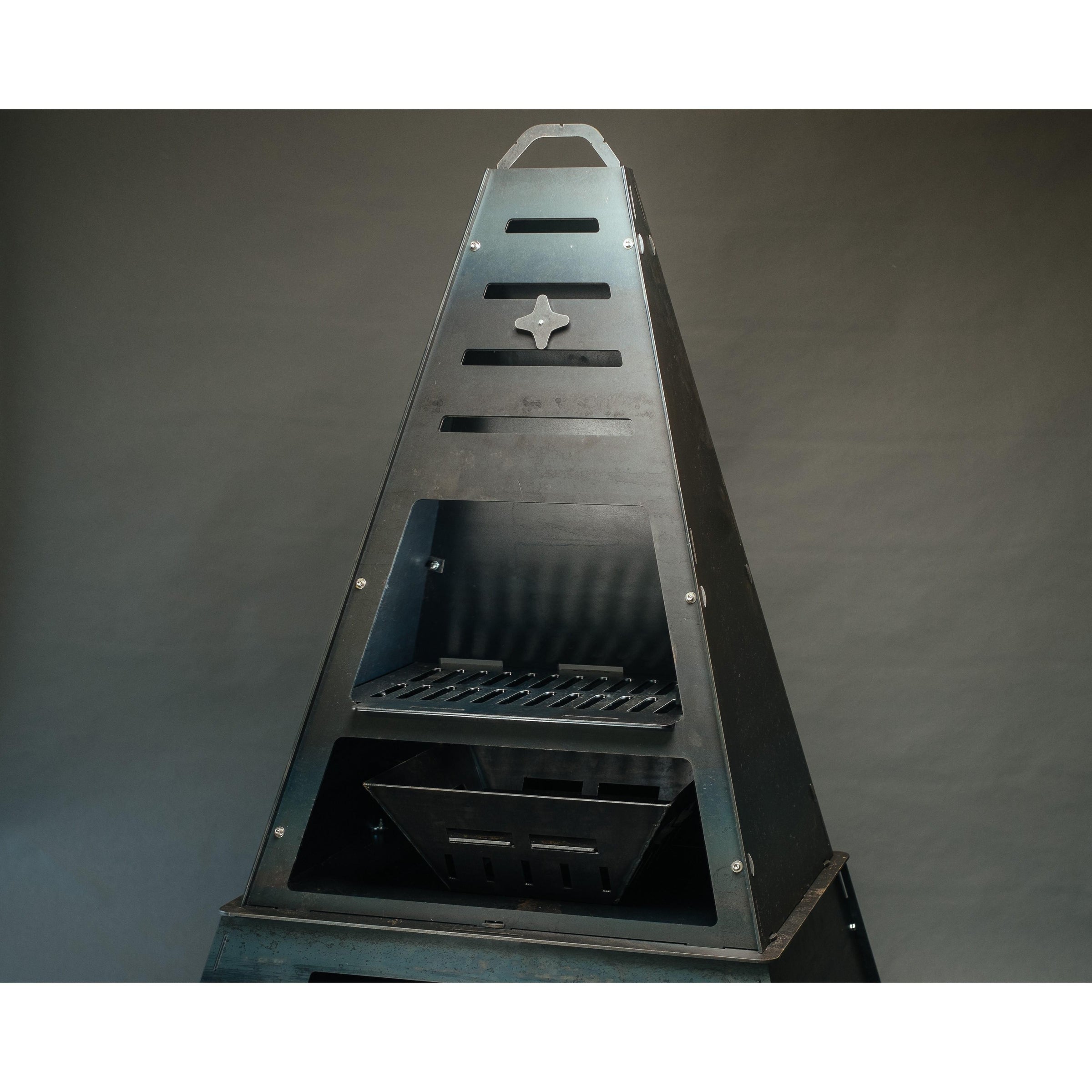 Pyro Tower chiminea — studio profile with fire in the chamber